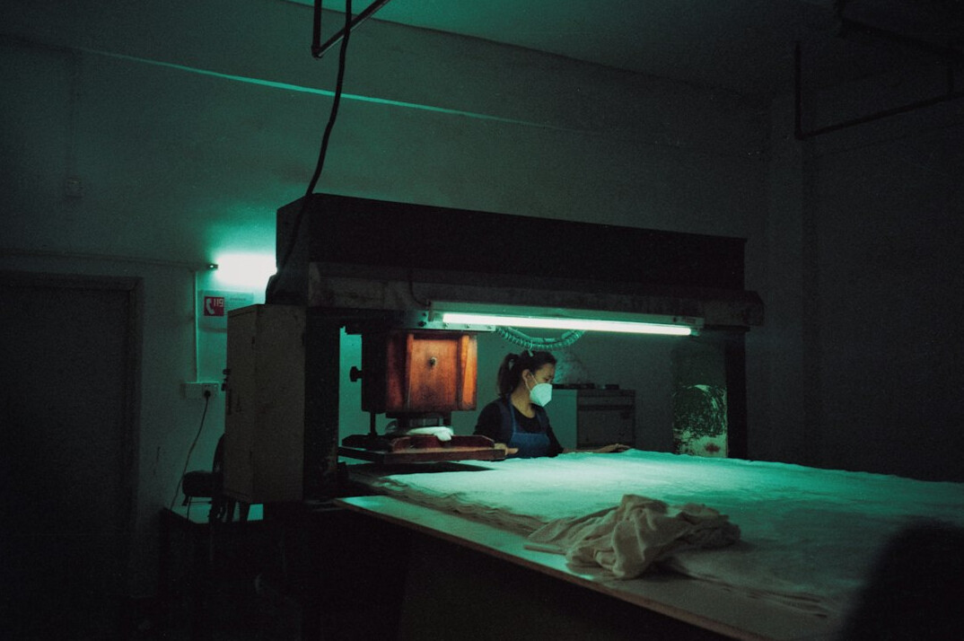 Documentary portrait of a man researcher at a desk with papers