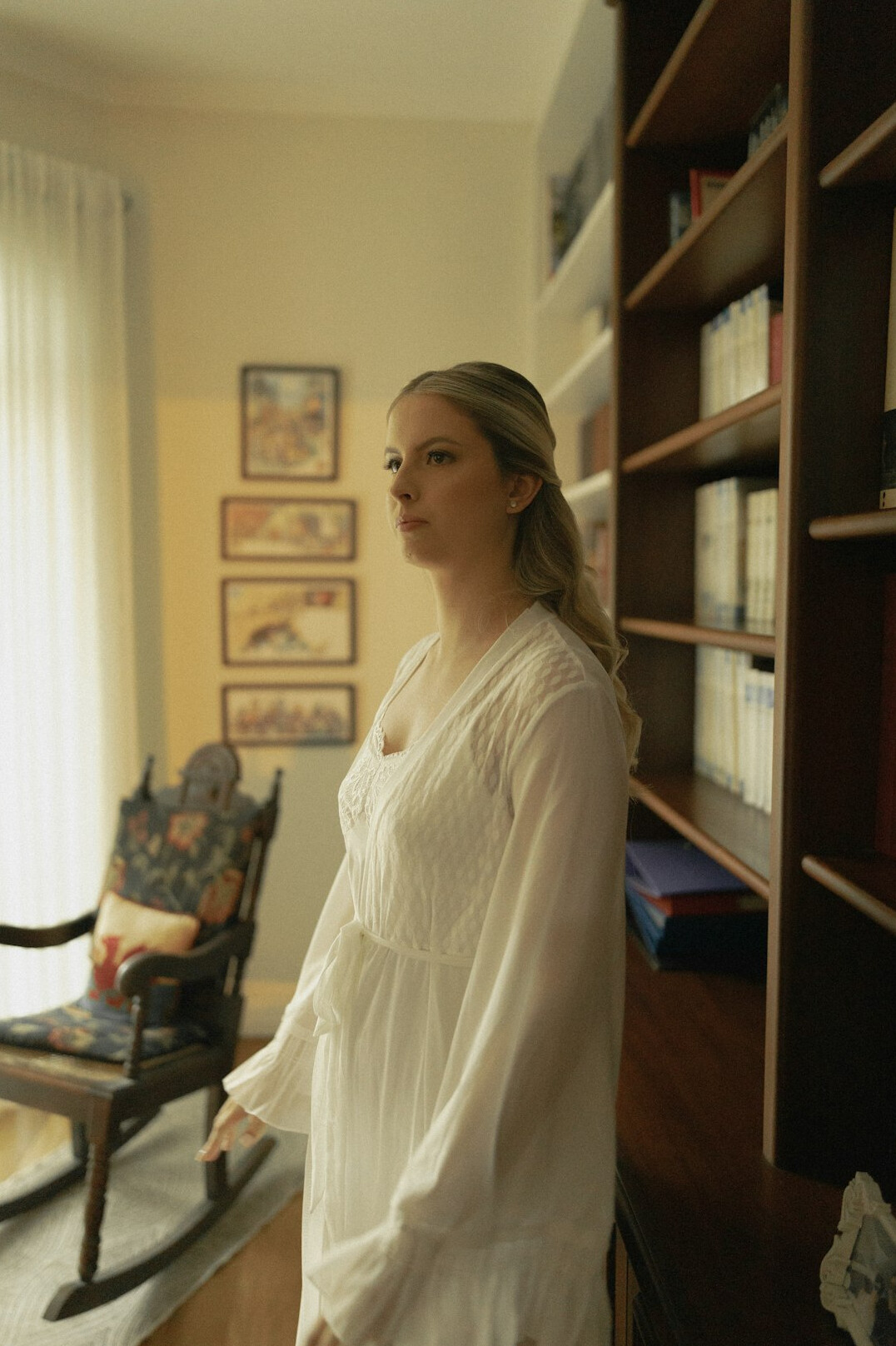 Documentary portrait of a woman sociologist near a bookshelf