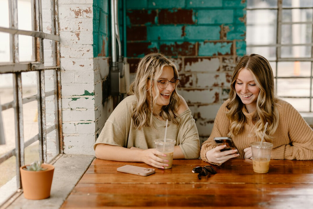 friends using smartphones together